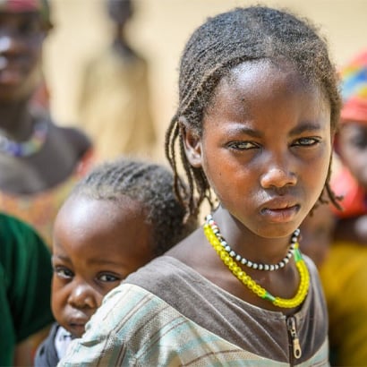 a girl and a baby staring at the camera