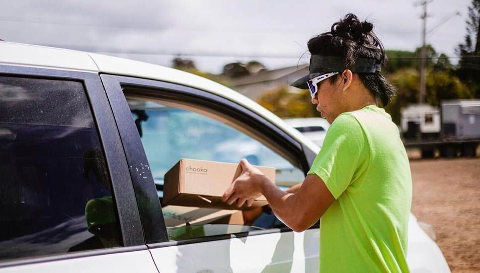 woman handing someone a box