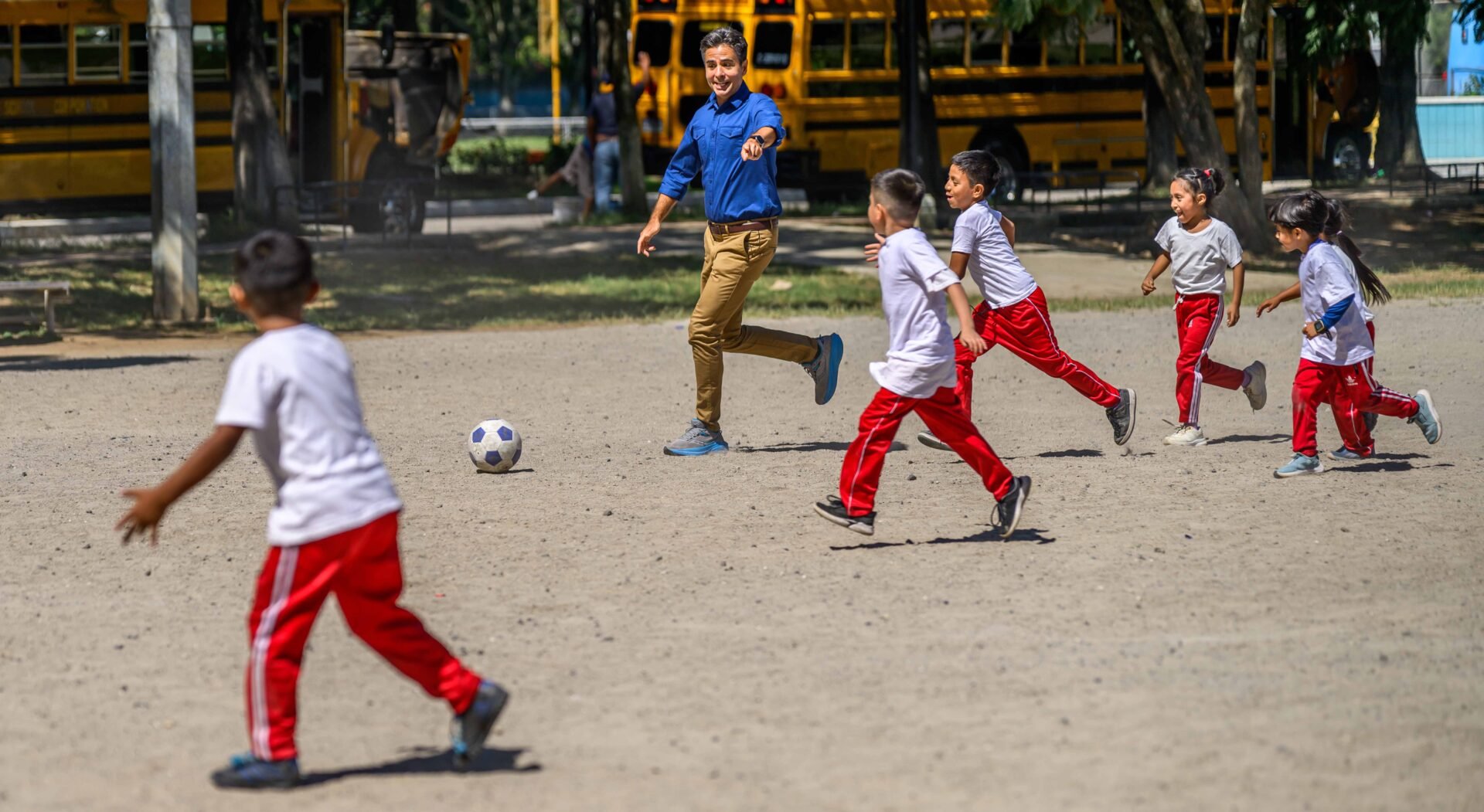 edgar playing soccer with kids