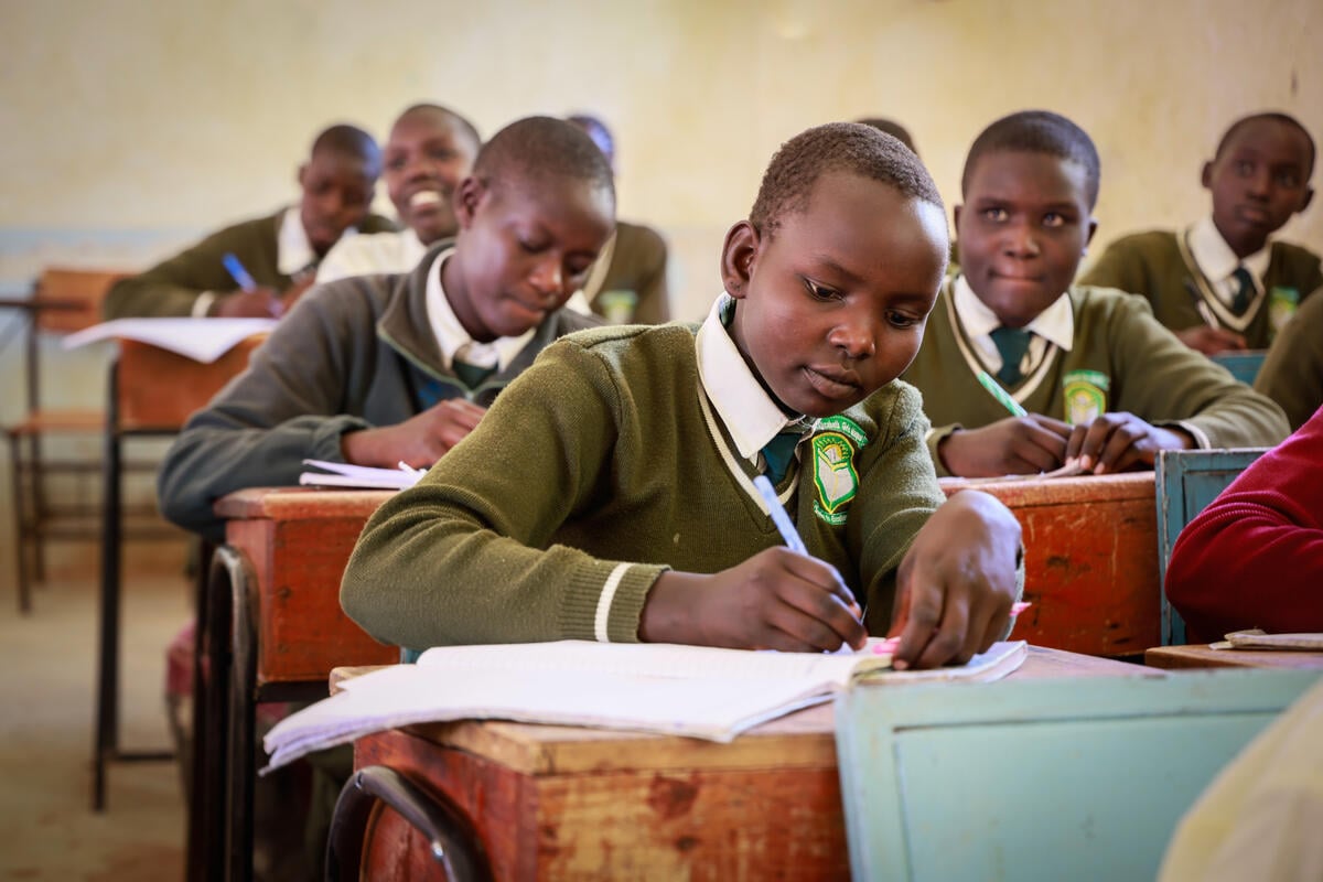 A classroom setting with schoolgirls, each concentrating on their lessons. 