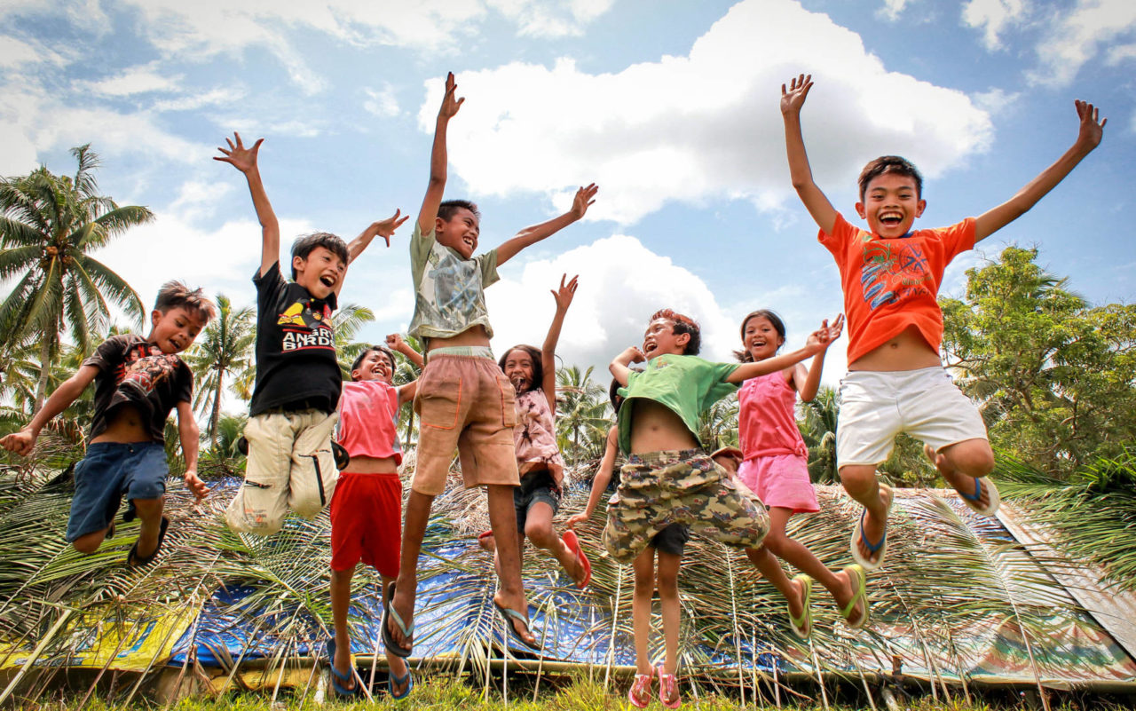Joyful children in World Vision project jump and play &copy;World Vision
