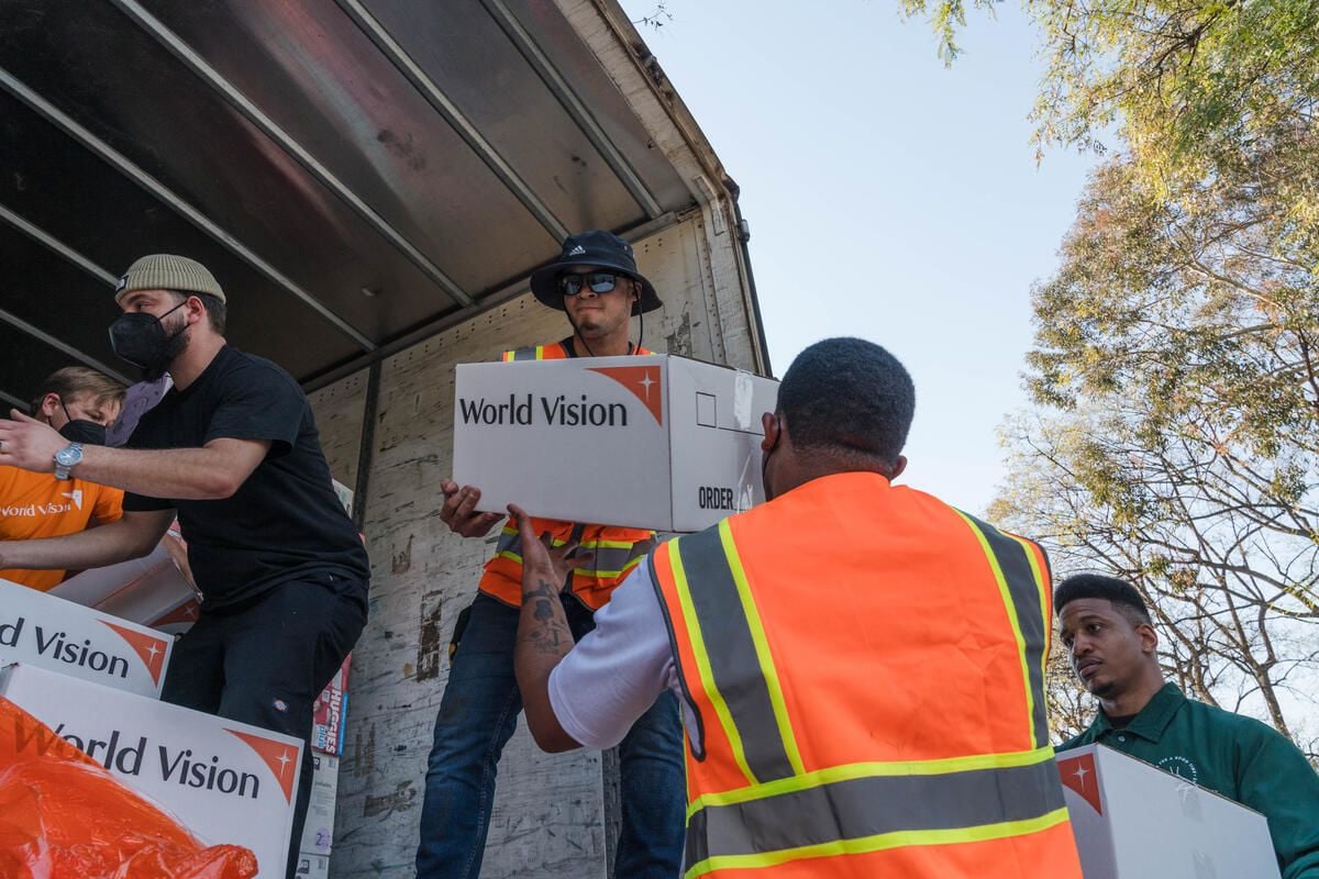 man handing someone a box