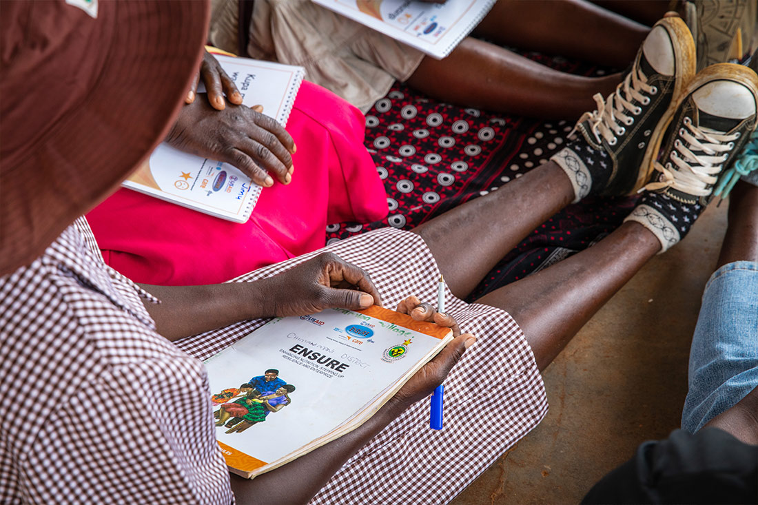 A woman holds a care group curriculum