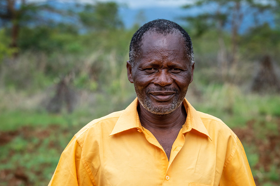 A man stands in a village.