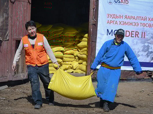 two men carrying emergency supplies