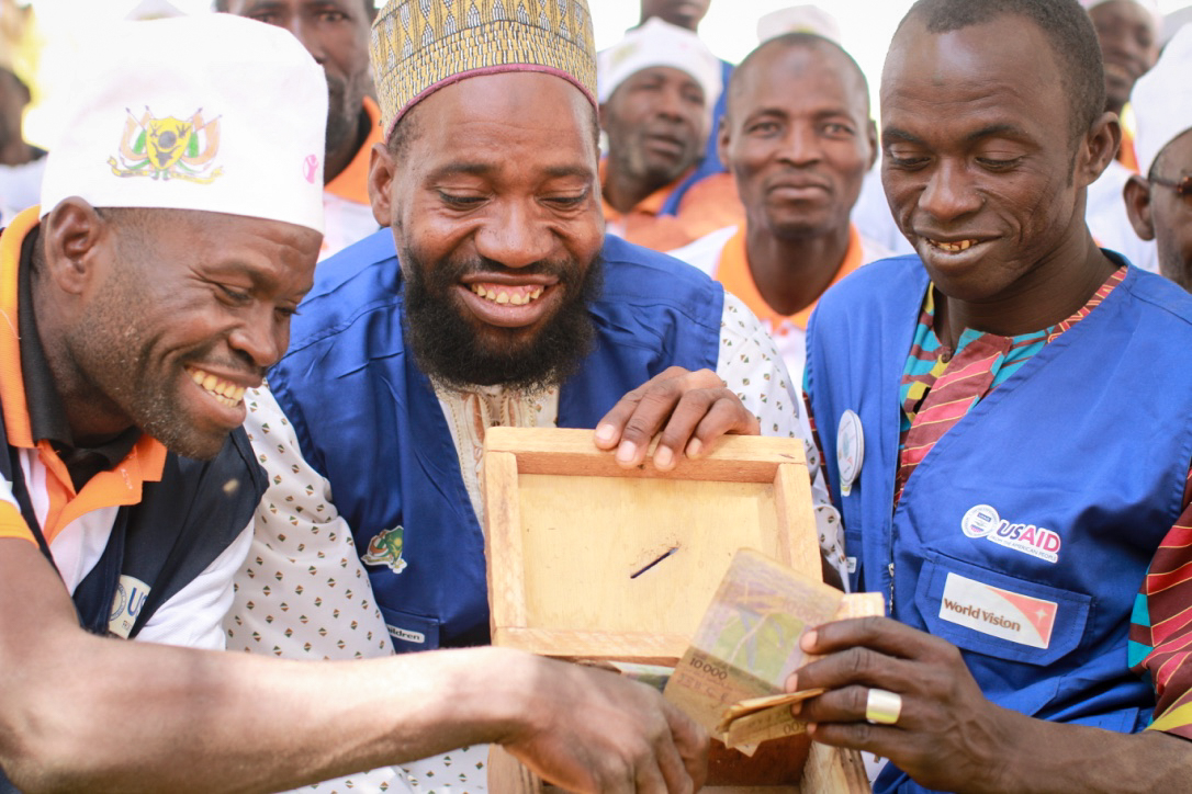 Members of the husband's school contribute funds each month for village projects like a maternity center.