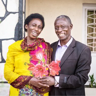 two people smiling holding hands together