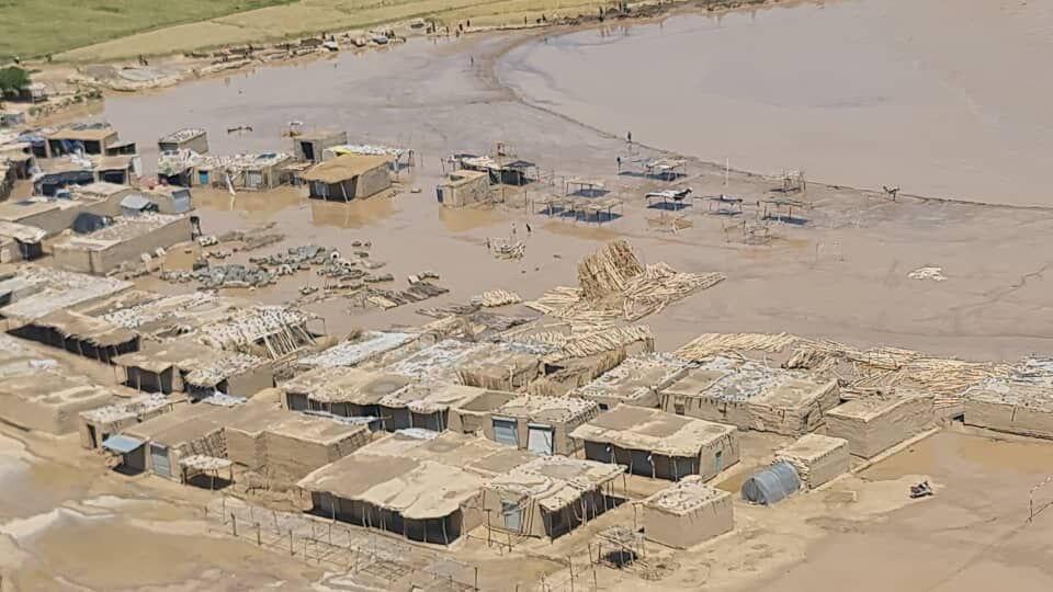 Aerial view of the landscape with muddy waters encroaching on structures following a flood.