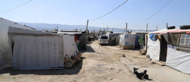 Arid soil holds an informal tented settlement in Lebanon, where World Vision provides support to children and their families.