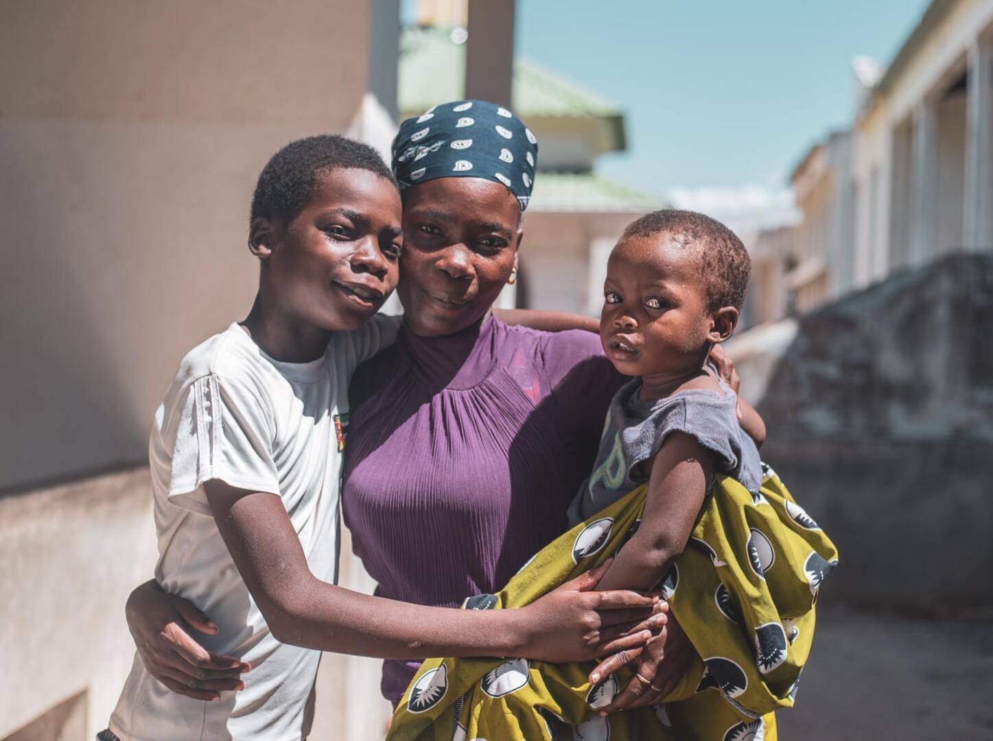 Louisa and children A family in Mozambique stands close to each other as they look at the camera.