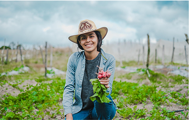 Yessica holding out radishes